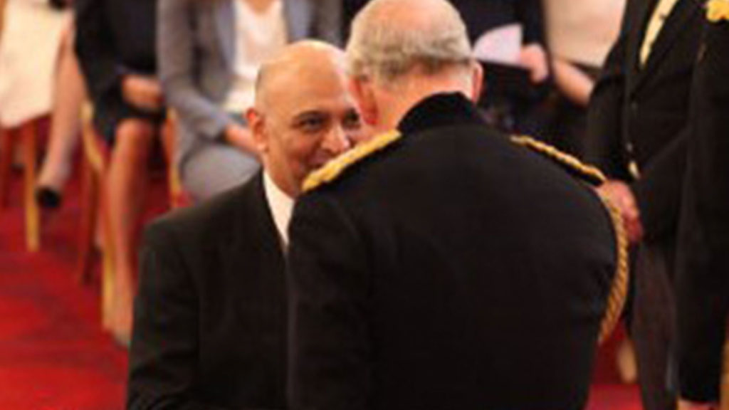 Dr Nik Kotecha OBE receiving an OBE from HRH Prince Charles.